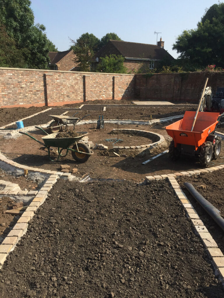 Construction of round feature with planted beds surrounding it