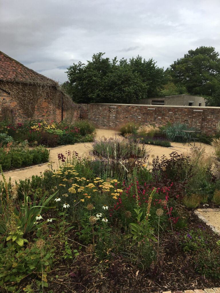 Completed round feature path with planted beds