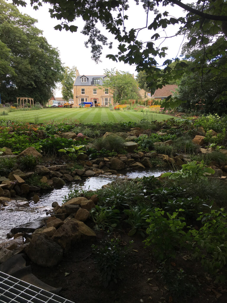 Water feature and newly laid lawn